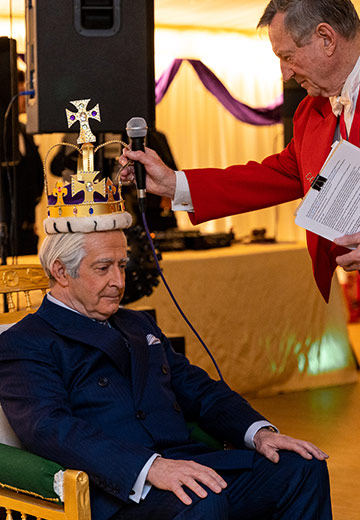 Charles Haslett as King Charles, with authentic royal attire and distinguished poise